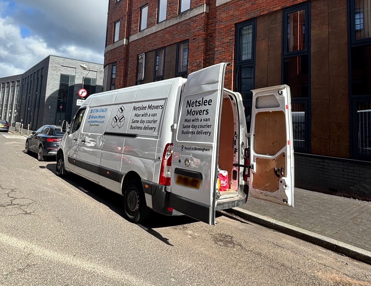 Netslee Movers van with open doors displaying large capacity for deliveries