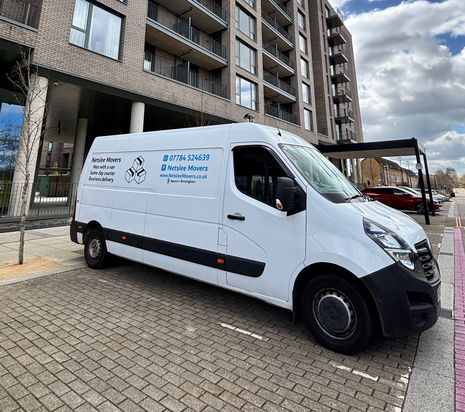 Netslee Movers van parked in residential area ready for delivery service